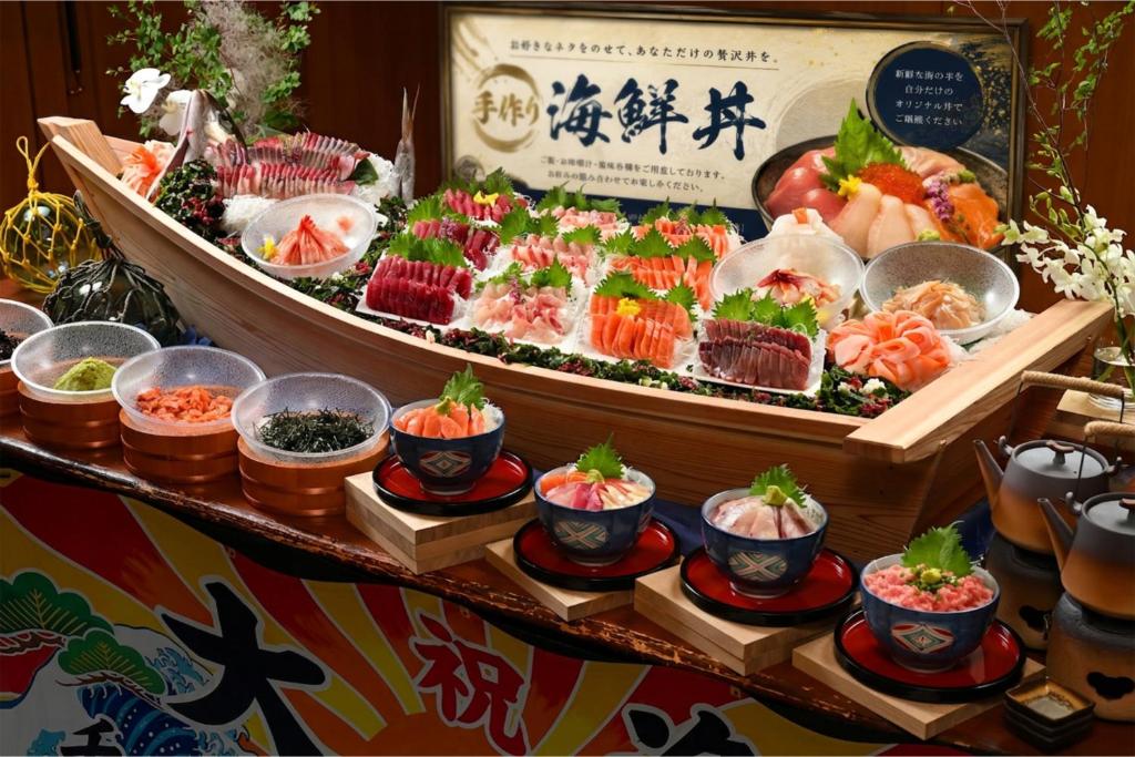 a buffet of food with sushi and other foods at Iwaki Washington Hotel in Iwaki