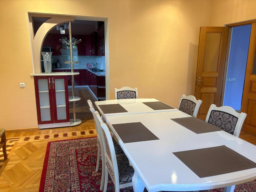 a dining room with a white table and chairs at BEAUTI-House in Ijevan