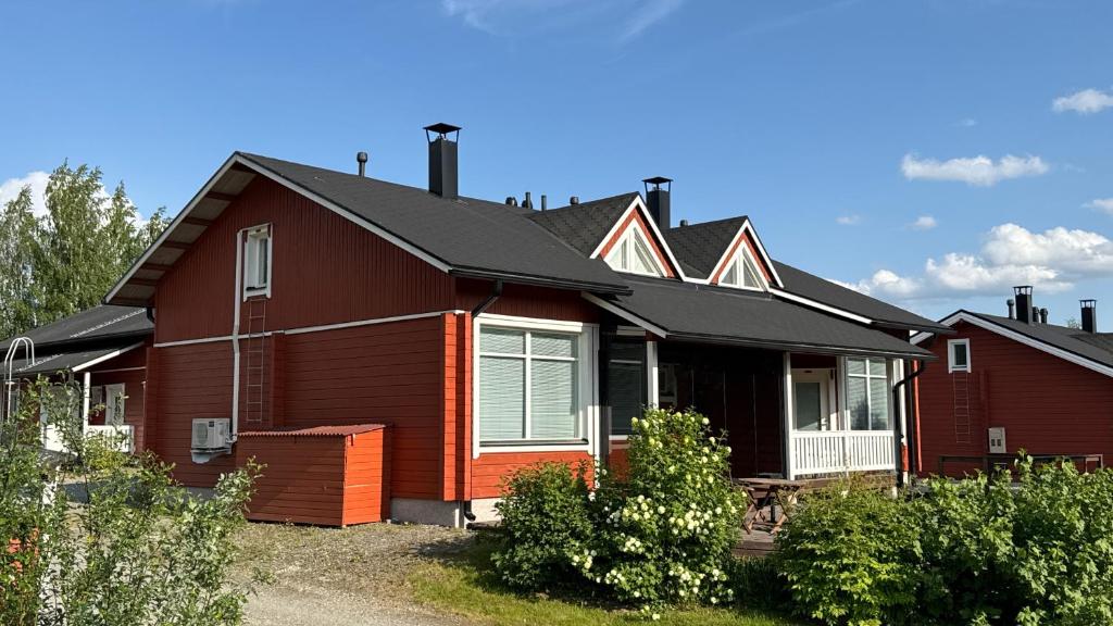 a brown house with a black roof at Koivulantie 11 A 2 in Tahkovuori