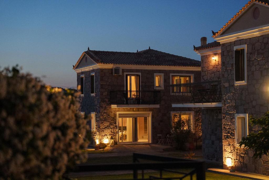 a large stone house at night with lights at Anasa Villas in Mythimna