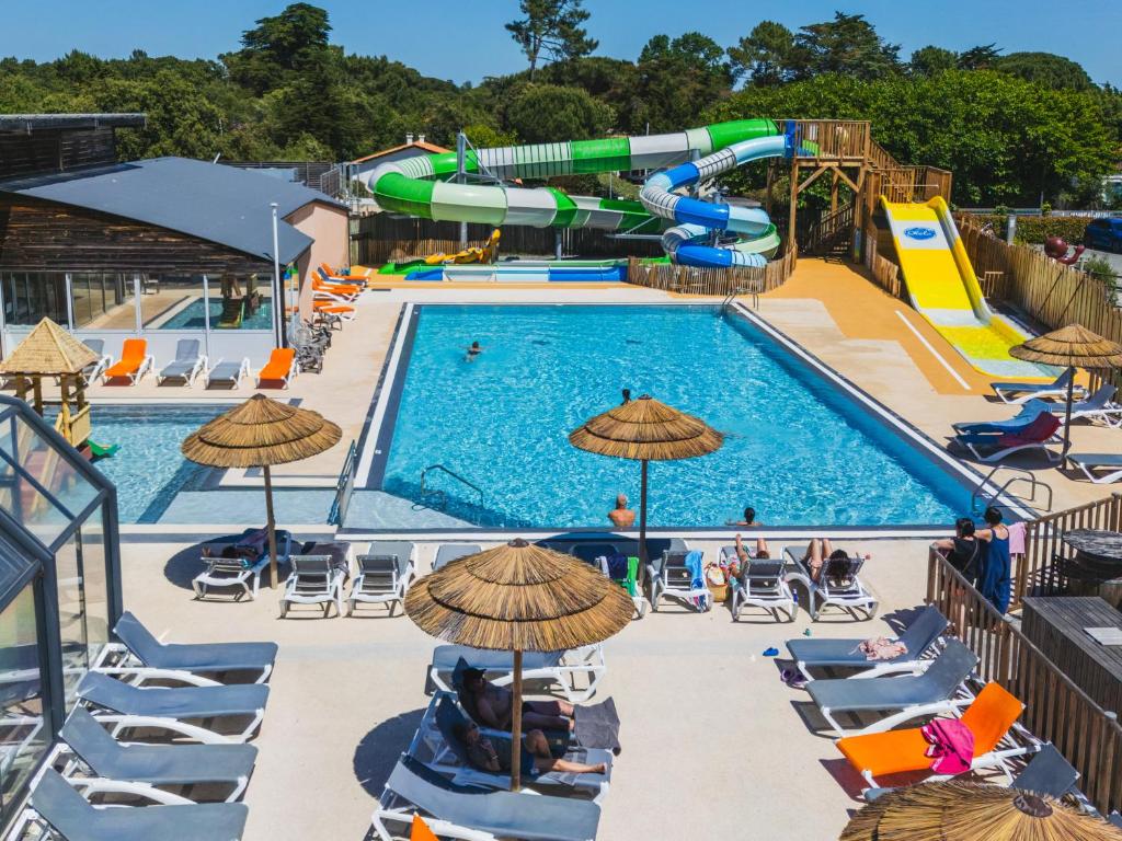 a pool with a water park with a water slide at Camping Signol in Boyard-Ville