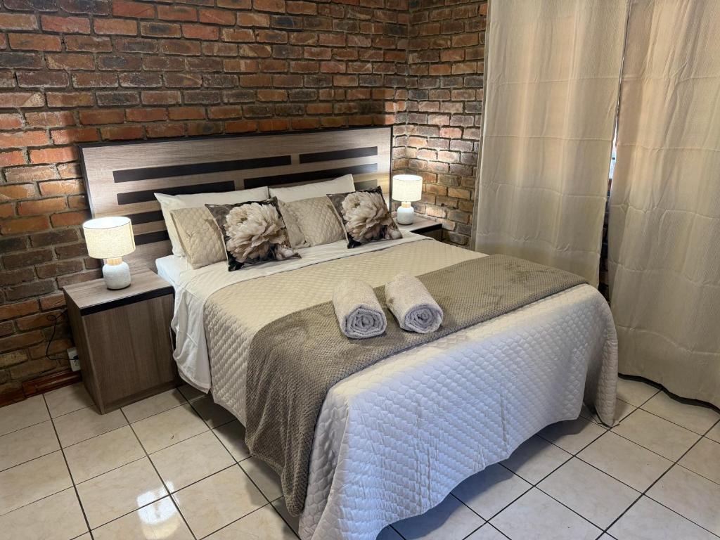 a bedroom with a bed with two dogs on it at The Willows in Polokwane
