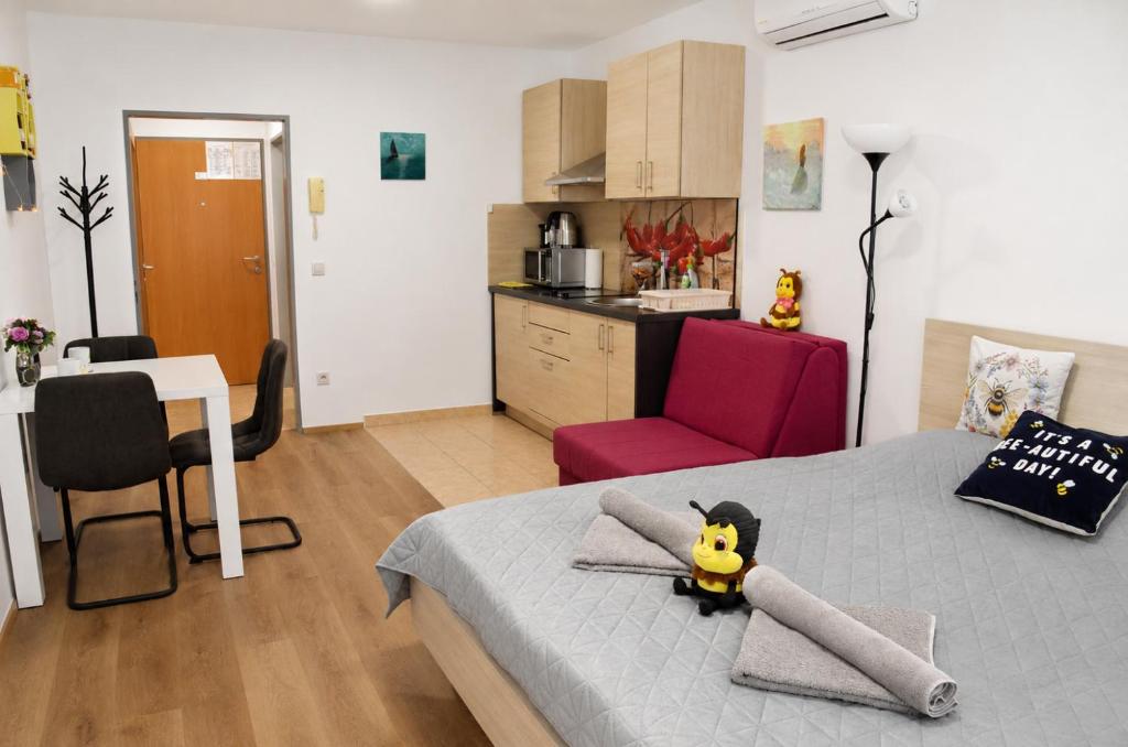 a bedroom with a bed with a toy on it at Honey Apartment in Moravske-Toplice