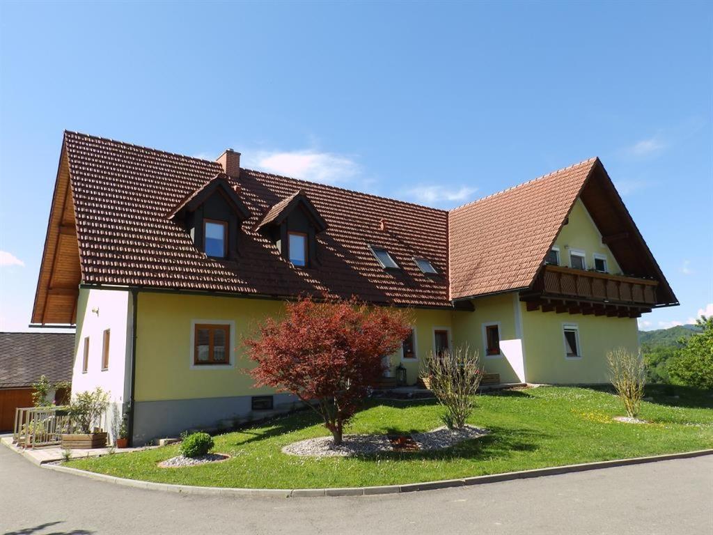 a large house with a brown roof at Obst- und Weinbauernhof BERNHARD in Leutschach