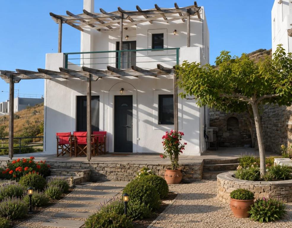 a white house with a red bench on a patio at Ravishing View, Zastani Houses in Marmari