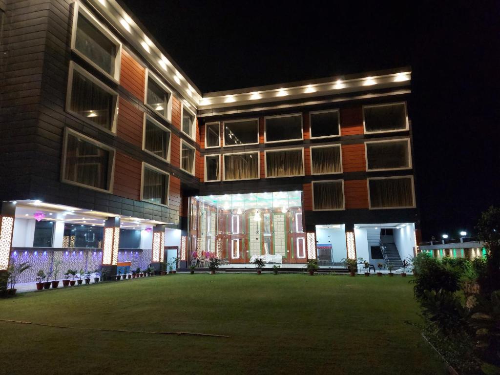 a building with a lawn in front of it at night at Hotel SS Grand in Lucknow