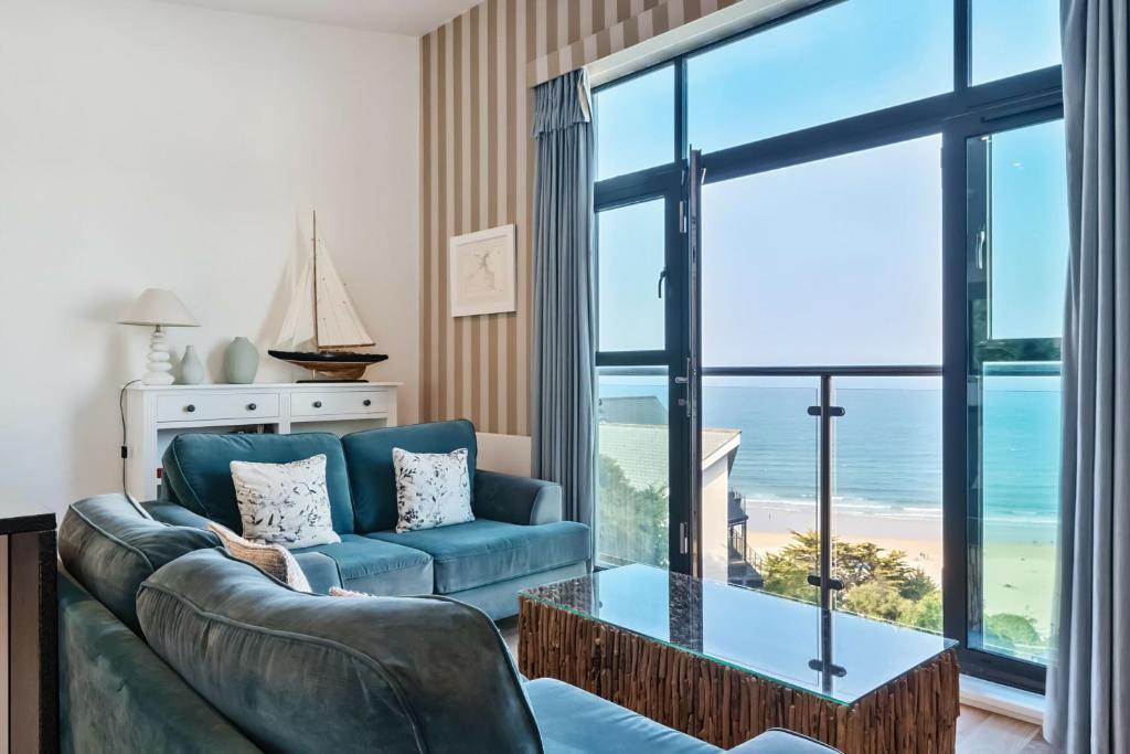 a living room with a couch and a table at Porthminster Mews 2 in St Ives