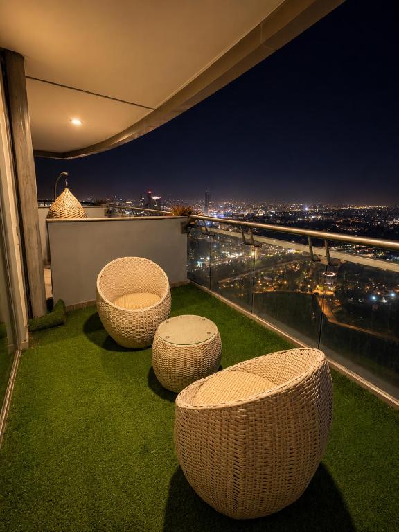 a balcony with a view of a city at night at Skyvera Stay at Supernova Spira in New Delhi