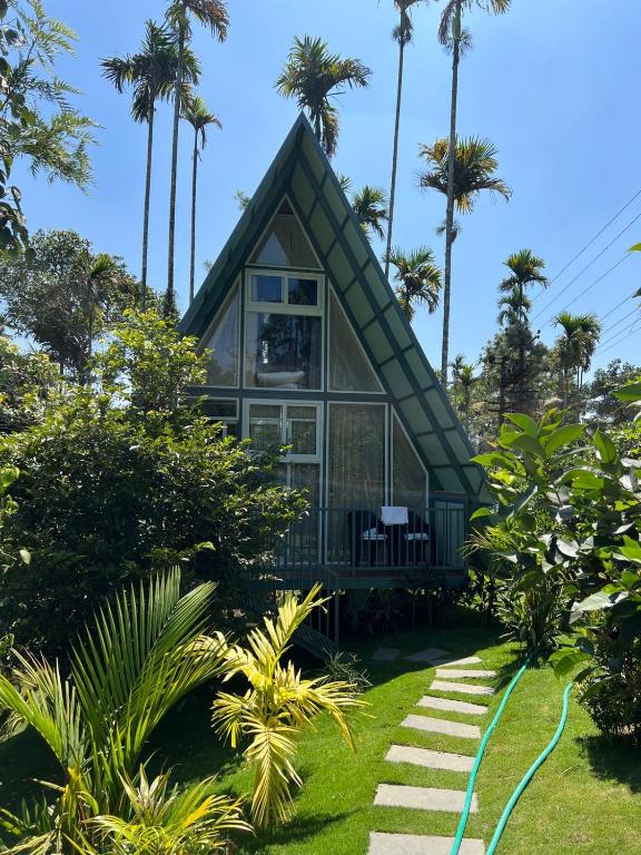 a house on the beach with palm trees at Wild Nest Resort, Wayanad in Meppādi