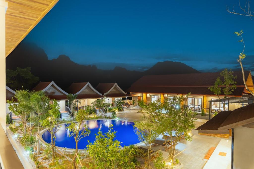 an overhead view of a resort pool at night at Sunset Mountain View Resort in Vang Vieng