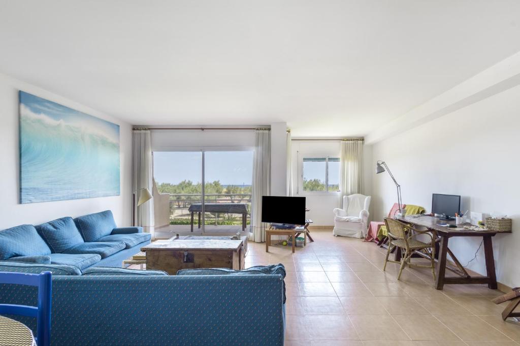 a living room with blue couches and a table at Port Pals B202 in Pals
