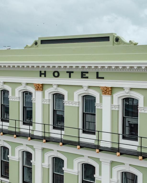 a white building with a hotel sign on it at The Empire Hotel in Timaru