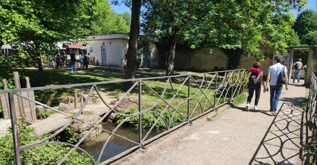 a group of people walking over a metal bridge at Pop Up Village in Villasanta