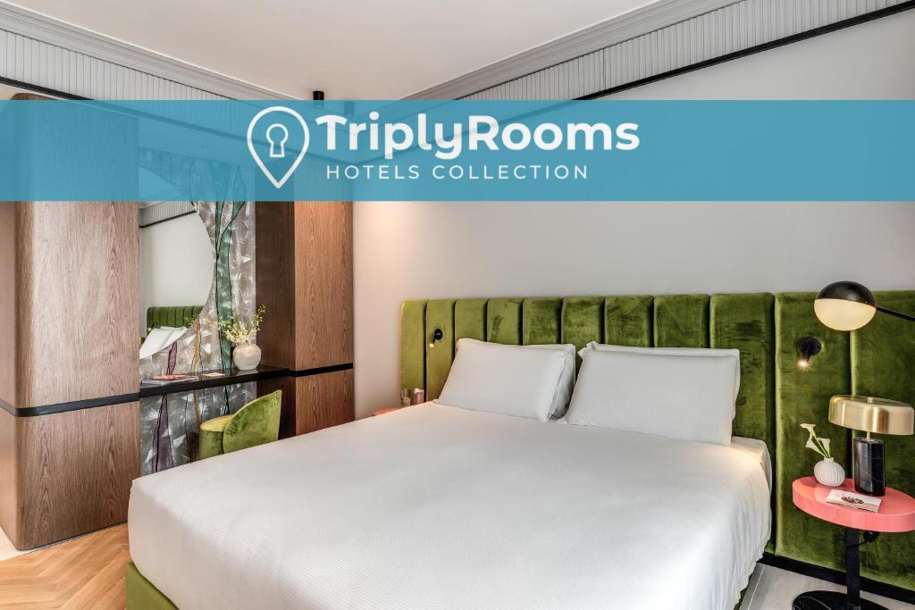 a bedroom with a white bed and a green headboard at TriplyRooms Collection - Roma Prassede in Rome