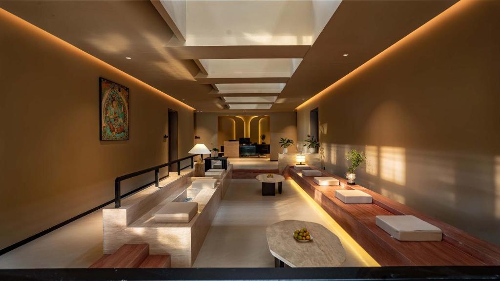 a large lobby with couches and tables in a building at Qinxiang Pavilion Hotel in Dunhuang