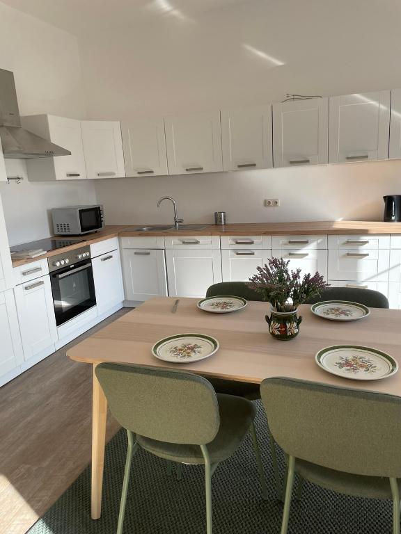 a kitchen with a wooden table with chairs and a tableasteryasteryasteryasteryastery at Ferienwohung in Maissau in Maissau