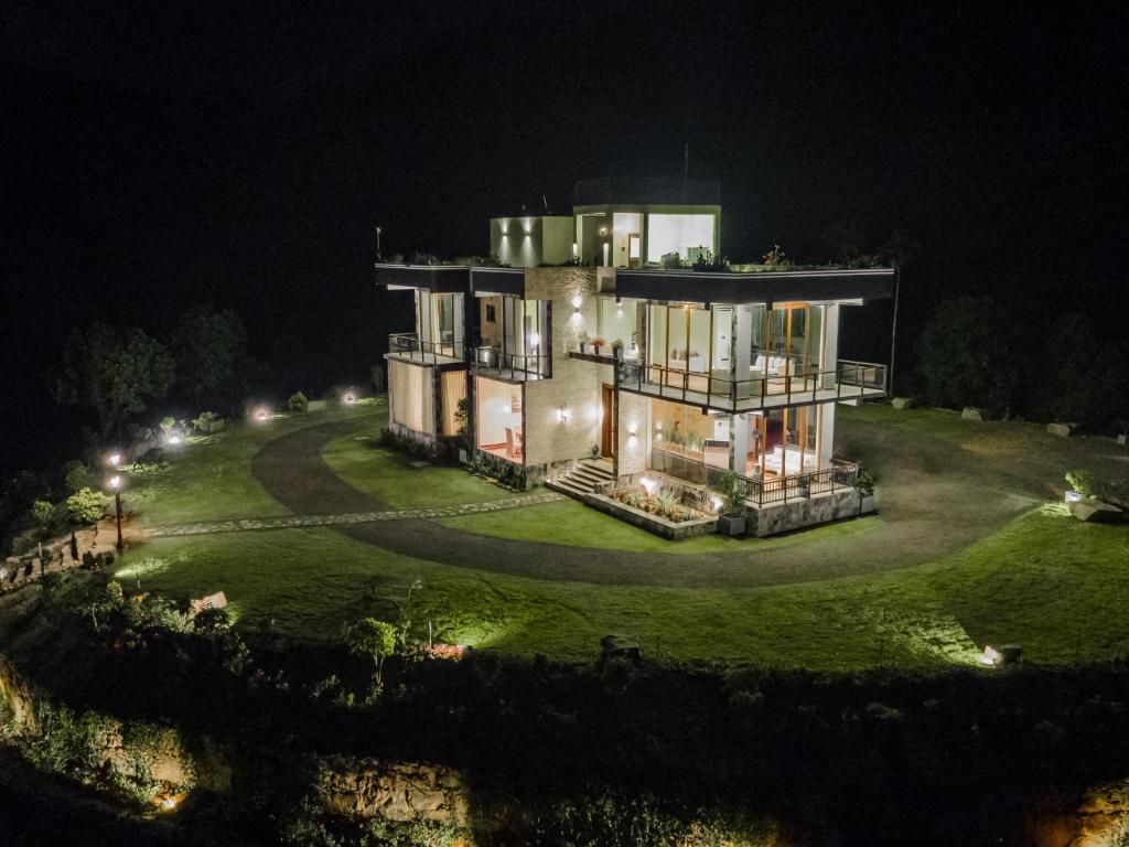 an aerial view of a large house at night at Beverly Hills Retreat in Kandilpana