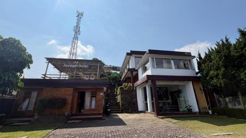a house with a sign on top of it at Jayagiri Inn in Tangkubanperahu