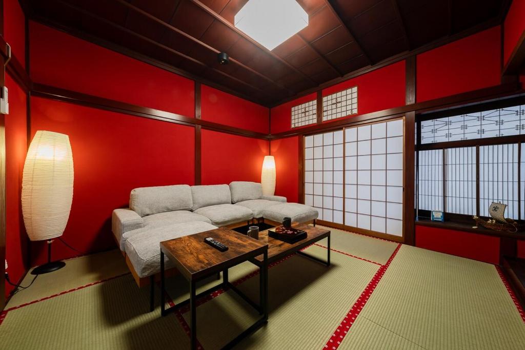 a living room with a couch and a table at 金沢町家 凛 in Kanazawa