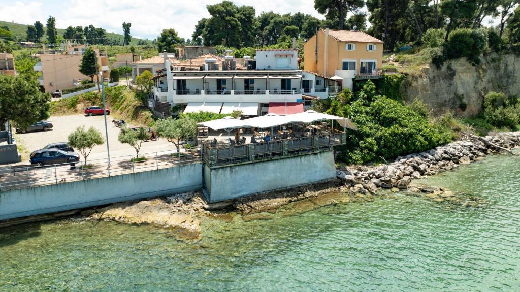 a building on a bridge over a river at ARTEMIS ROOMS in Pefki