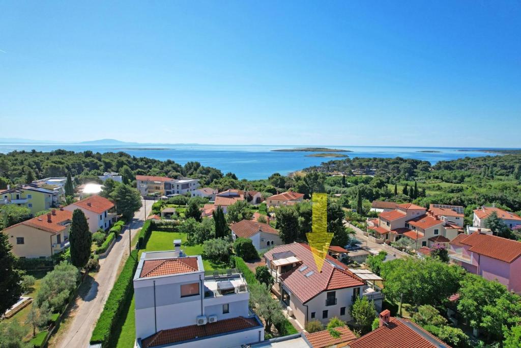 an aerial view of a small town with houses and the ocean at Apartment House with Shared Pool in Premantura