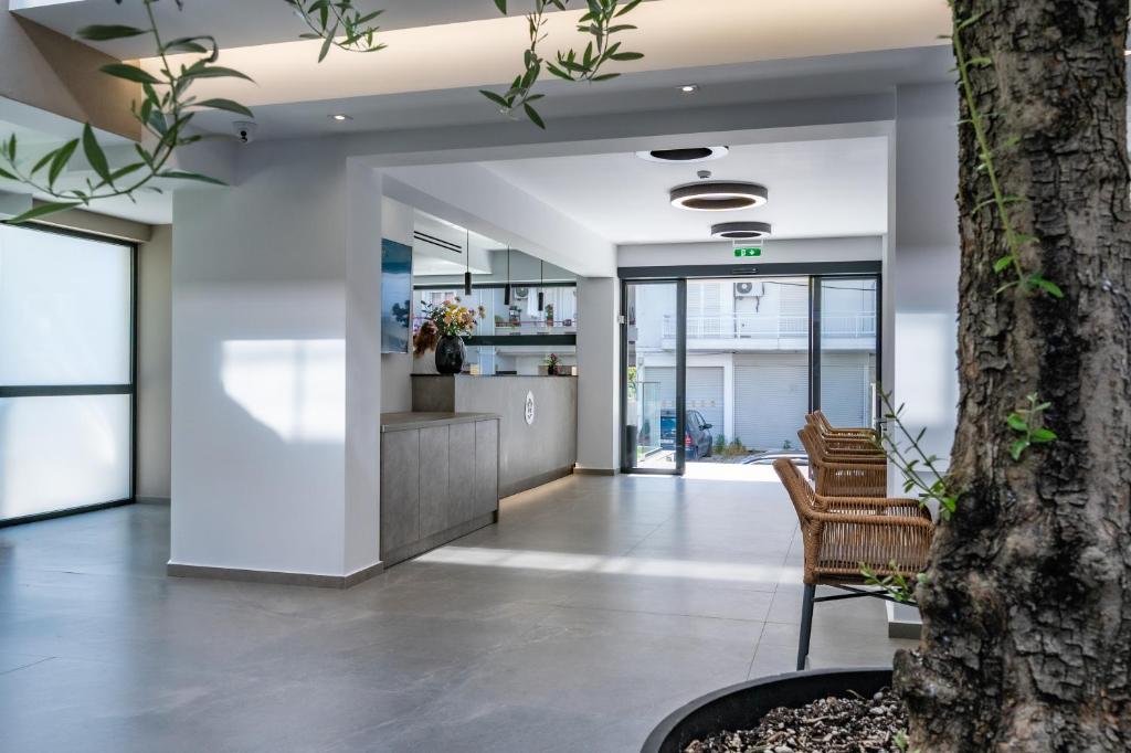 an office lobby with chairs and a tree at Olympus Jankaea in Paralia Katerinis