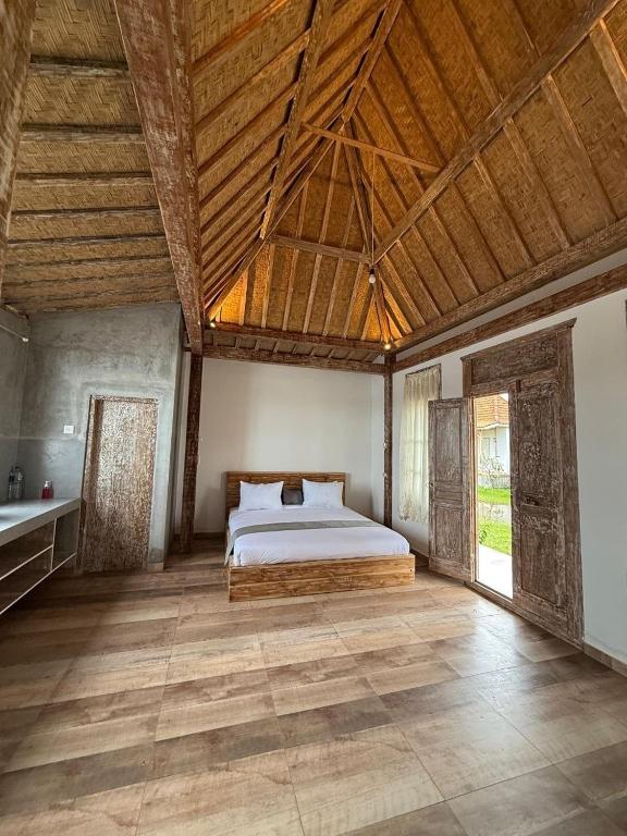 a bedroom with a bed and a wooden ceiling at Bali Eco Living Yoga Healing Meditation and Retreat Center in Denpasar