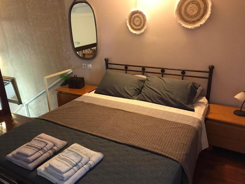 a bedroom with a bed with two towels on it at Olympus Eco Gaia in Plaka Litochorou
