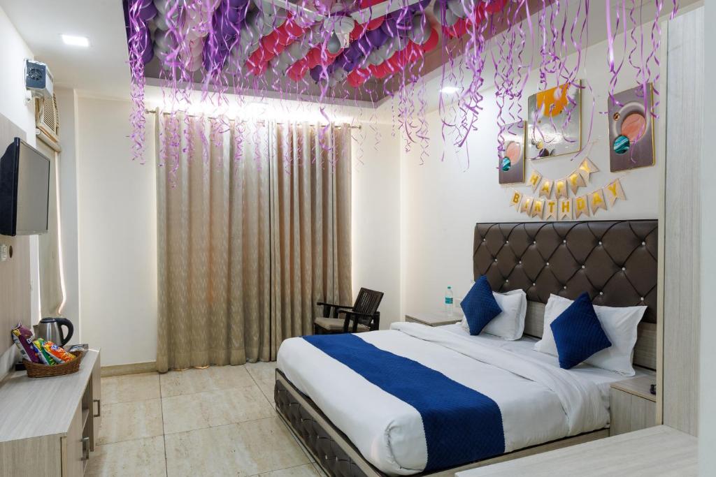 a bedroom with a bed with purple and pink decorations at Hotel Ornate Residency And Suites in Gurgaon