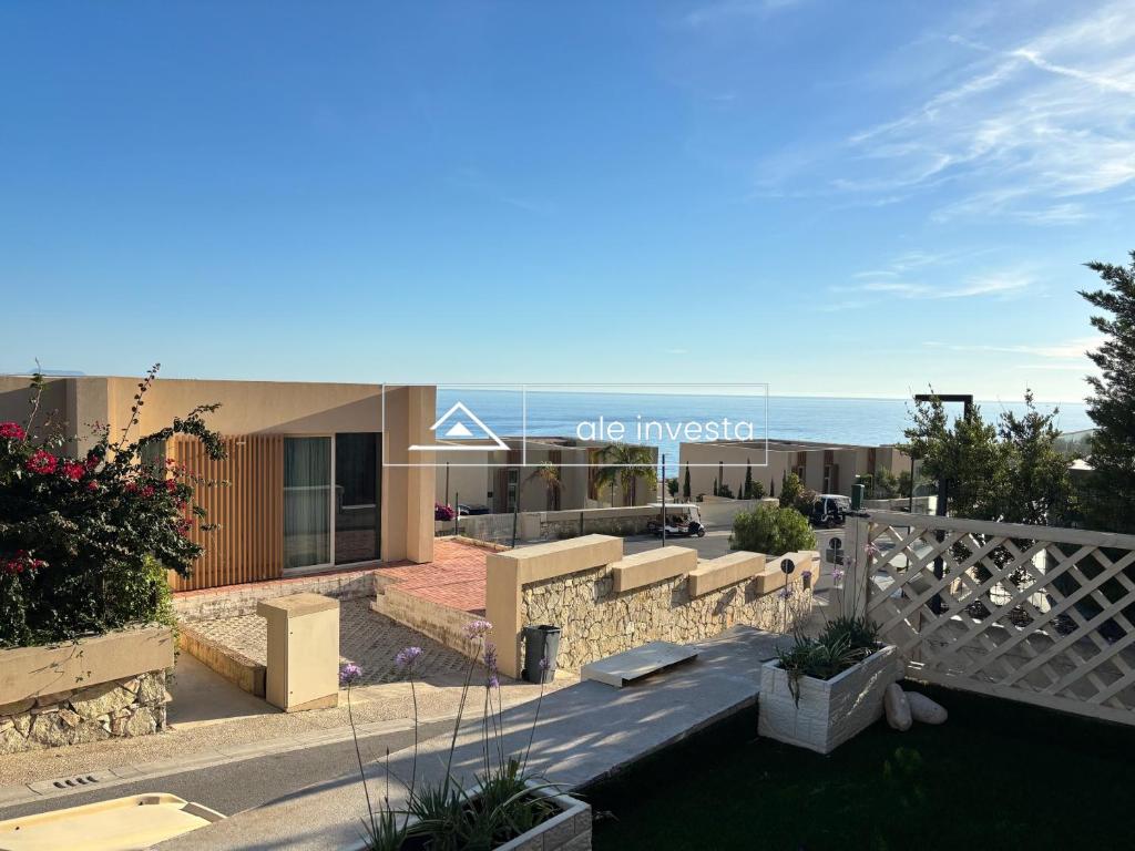 a view of a building with the ocean in the background at Green Coast 153a - by Ale Investa in Palasë