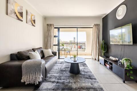a living room with a couch and a table at Above Cozy Corner Amsterdam in Northriding