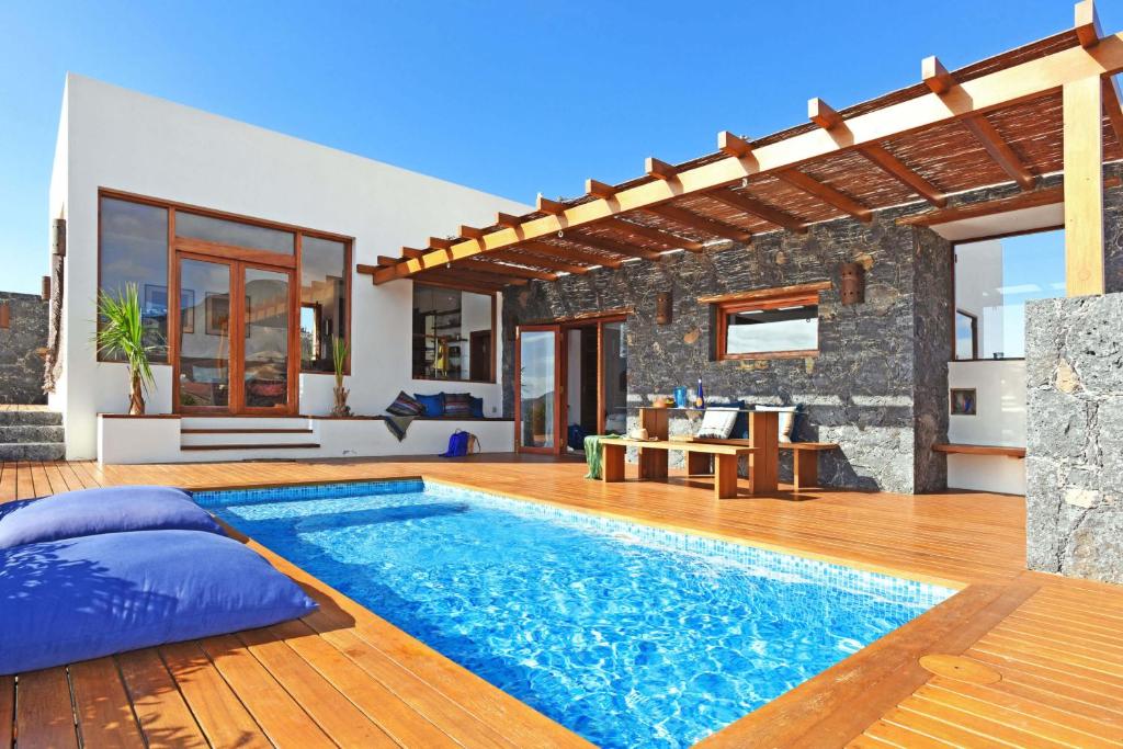 a villa with a swimming pool and a patio at Casa San Luis in Pájara