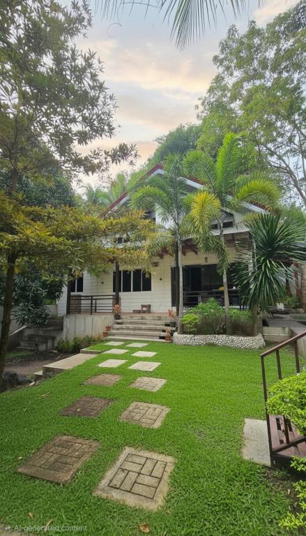 a house with a lawn in front of it at DonnRaqui's Hidden Zen in Iligan
