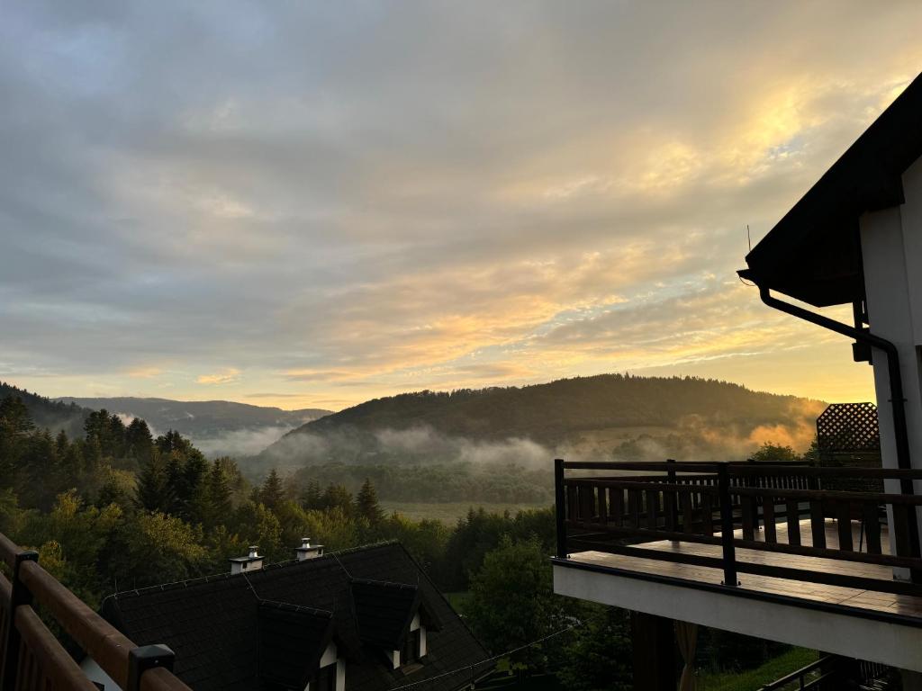 a view of the mountains from a balcony of a house at Apartamenty Wilcza Knieja in Zawóz