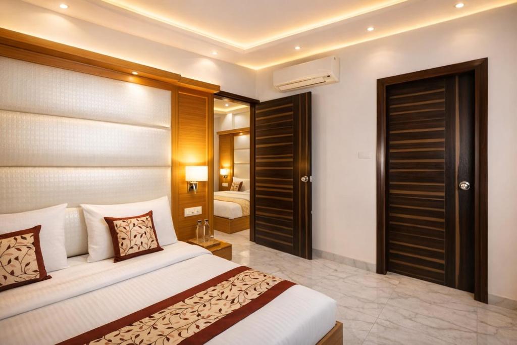 a hotel room with a bed and a bedroom at Hotel Aero Star by Star Group in New Delhi
