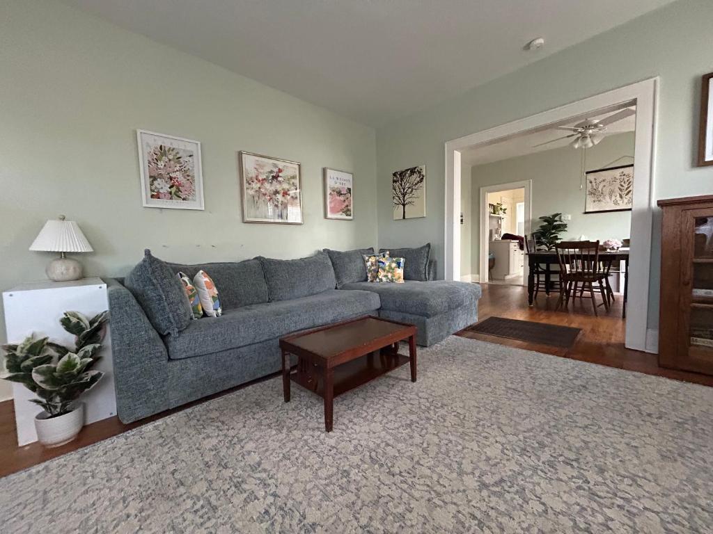 a living room with a blue couch and a table at Tranquility Corner in Ashland