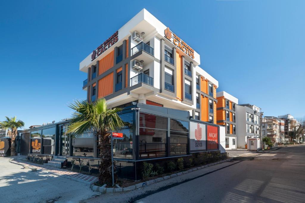 a building with a palm tree in front of it at The Orange Cactus in Antalya