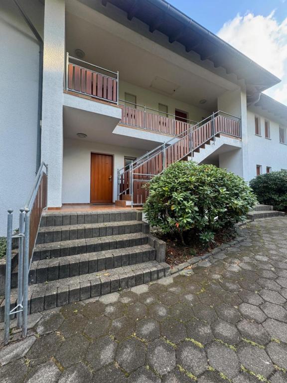 a building with stairs and a wooden door at Ferienwohnung Hunsrückblick in Thalfang