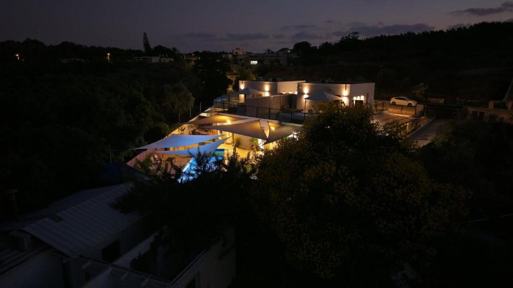 an aerial view of a building at night at קולינה וארדה in ‘Amqa