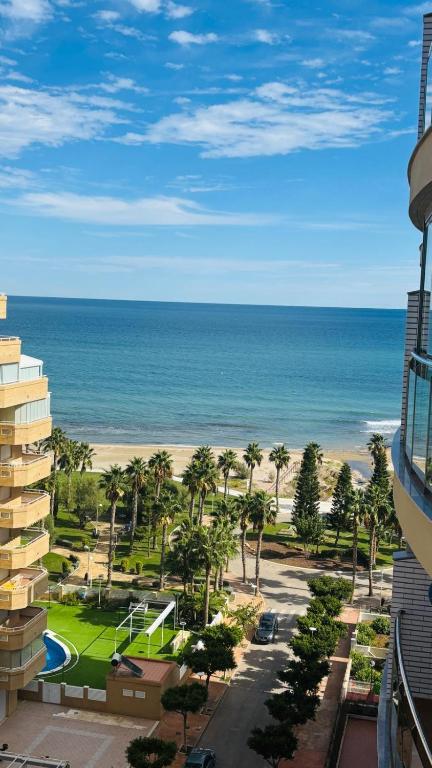 a view of the beach and the ocean from a building at F10 - Vila D Orpesa X, World Lujo - ServHouse in El Borseral
