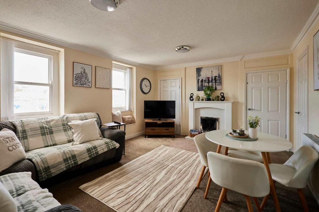 a living room with a couch and a table at Host & Stay - Cobblers Cottage in Whitby