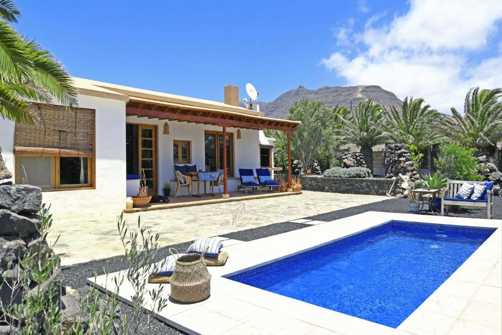 a villa with a swimming pool and a house at Casa Simbad in Pájara