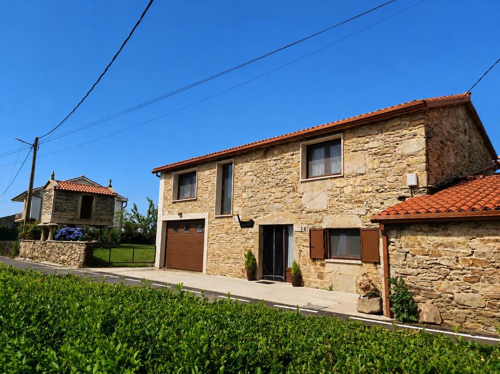 a stone house on the side of a street at Casa Souto in Santa Comba