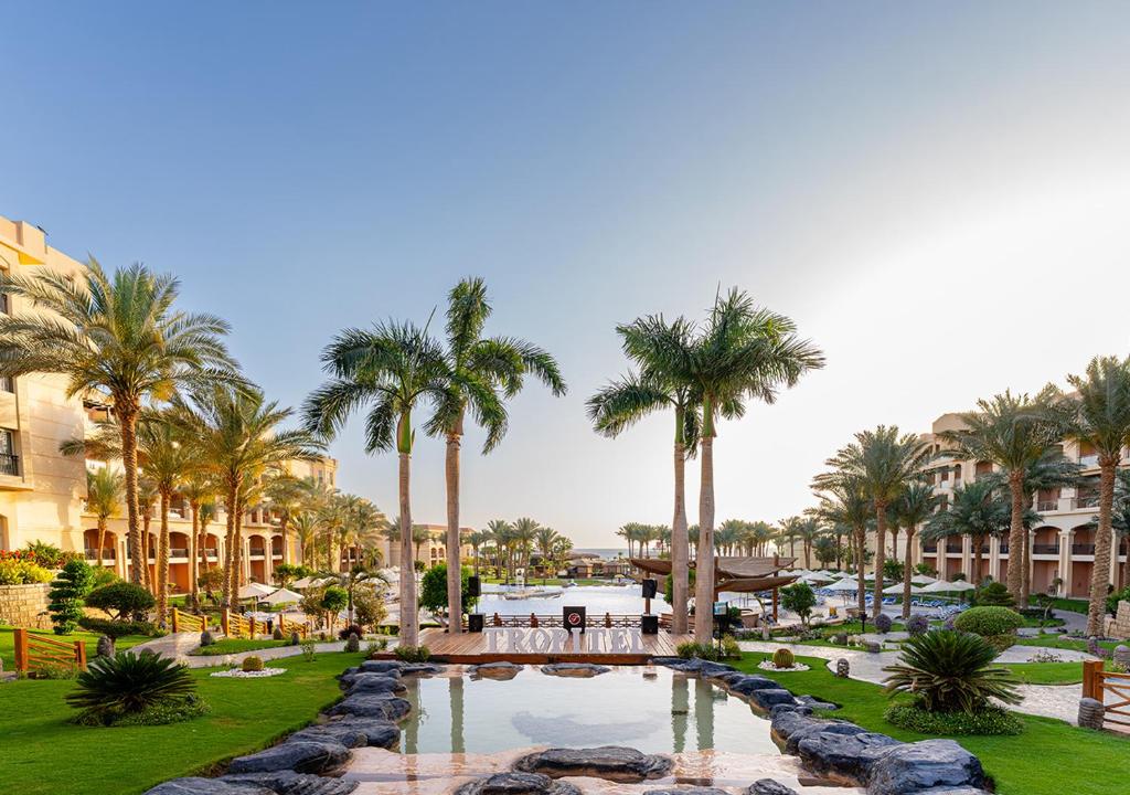 a view of a resort with a pool and palm trees at Tropitel Sahl Hasheesh in Hurghada