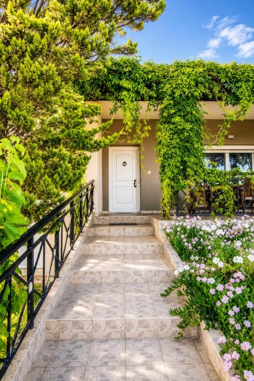 a walkway leading to a house with flowers at Hill View 4 in Alexandroupoli