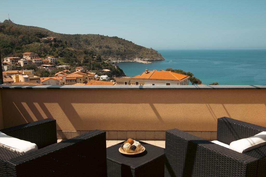 a plate of food on a table on a balcony at Meublé Leonetti in Palinuro
