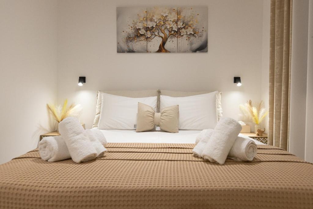 a bedroom with a bed with towels on it at Elysian Studios in Mavrovouni