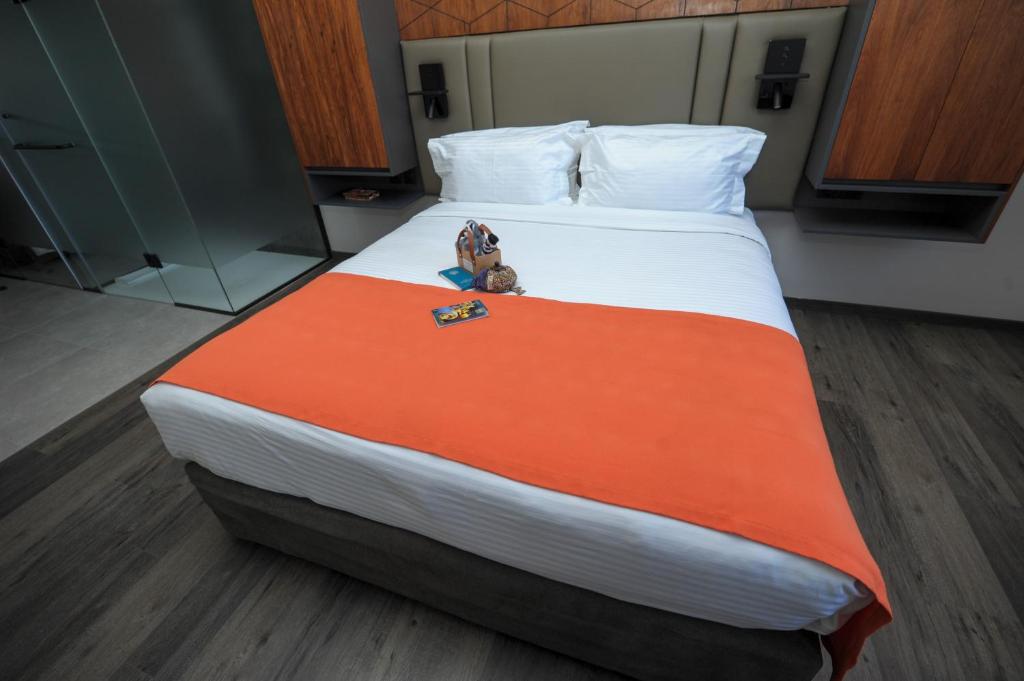 a bed with a teddy bear sitting on top of it at Le Louvre Hotel & Spa in Antananarivo