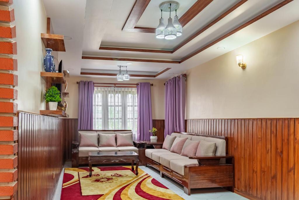 a living room with a couch and a table at Comfort Apartment in Bālāju