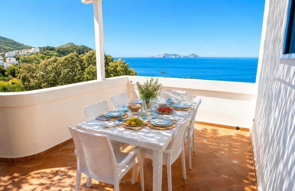 a table on the balcony with a view of the ocean at Maridea - Magia di Circe in Ponza